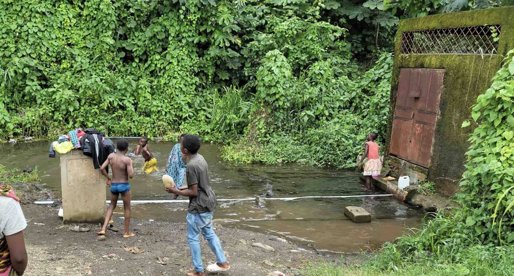 Children playing in the stream at the Ndongo water catchment